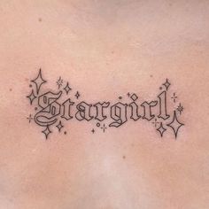 the back of a woman's stomach with an inscription tattoo on it that reads, stargirl