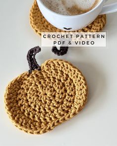 crochet pumpkin coasters with coffee in the background