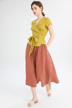 "Add a pop of color to your wardrobe with our yellow V-neck linen fitted short sleeve top. The fitted design hugs your curves in all the right places, while the breathable linen fabric keeps you feeling cool and comfortable. The V-neckline adds a touch of elegance, making it the perfect top for any occasion. Pair it with your favorite jeans or a skirt for a chic and effortless look. DETAIL: * 100%Linen * V neckline * Short sleeve * Loose linen shirt * Wrap blouse * Perfect for Spring, Summer, an V-neck Linen Blouse For Work, Casual Yellow Linen Blouse, V-neck Linen Blouse For Summer, Yellow Linen Summer Tops, Green Linen Summer Blouse, Summer Green Linen Blouse, Spring Green Linen Blouse, Green Linen Short Sleeve Blouse, Yellow Linen Tops For Spring