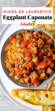 an eggplant caponata is served in a bowl with bread on the side