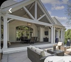 an outdoor living room and dining area with patio furniture