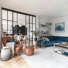 a living room filled with furniture and lots of windows