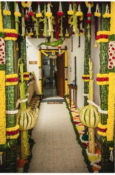 an entrance to a building decorated with flowers and plants on the outside, along with hanging lanterns