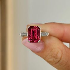 Three Stone Wedding Ring, Pink Garnet Emerald Gemstone Ring, East To West Baguette Shape Engagement Ring, 925 Silver Ring, Prong Set Ring Item Description: Stone - Simulated Diamond Shape- Emerald Cut Stone - Simulated Diamond Shape- Baguette Cut 1. White Gold: 10K/14K/18K 2. Yellow Gold: 10K/14K/18K 3. Rose Gold: 10K/14K/18K 4. Silver: Sterling Silver 925 Size Customization: What Size you want... * You can also Customize ring size in US 4 to US 12! It sometimes affects to price. * Main Stone & Shape Customization: Main Stone: Cubic Zirconia, Moissanite, Natural Diamond, CVD Diamond Shape Choice: Round Cut, Heart, Princess Cut, Pear Cut, Cushion Cut, Marquise, Oval Shape, Asscher, Emerald, Radiant, Old European Cut, Old Mine Cut * Check out Special Notes: At checkout, leave us a note in th Luxury Ruby Rectangular Rings, Luxury Baguette Cut Ruby Ring, Elegant Luxury Baguette-cut Ruby Ring, Wedding Ring Pink, Ruby Ring Silver, Three Stone Wedding Ring, Stone Wedding Ring, Pink Garnet, January Birthstone Rings