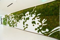 an office lobby with moss growing on the wall