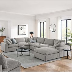 a living room filled with lots of furniture in it's centerpiece and large windows