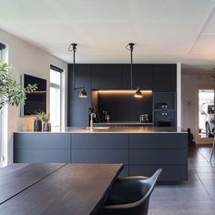 an open kitchen and dining room area in a modern home