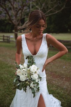 a woman in a wedding dress holding a bouquet