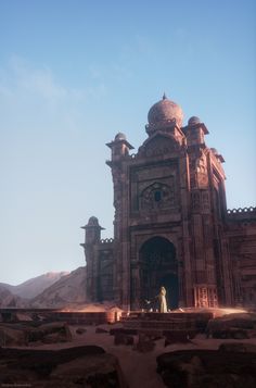 an old building in the middle of a desert with a person standing on top of it