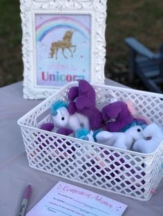 there are stuffed animals in a basket on the table