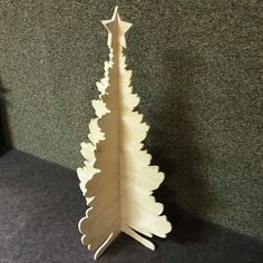 a wooden christmas tree on the ground