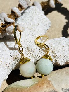 Handcrafted light green agate semi precious stone dangling earrings with brass embellishments on gold tone lever back closure. 12 mm agate stones. Elegant Amazonite Dangle Jewelry, Gold Agate Gemstone Earrings, Dangle Earrings With Amazonite And Natural Stones, Gold Agate Drop Earrings, Gold Agate Earrings For Jewelry Making, Gold Agate Earrings With Natural Stones, Gold Jade Gemstone Earrings, Gold Earrings With Natural Agate Stones, Gold Agate Earrings