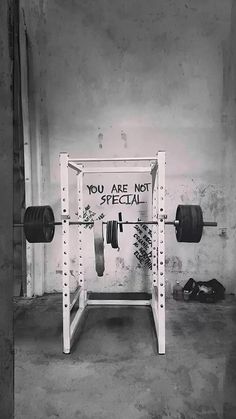 a black and white photo of a bench with a barbell in the middle that says, you are not special