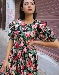 Floral midi dress in black and pink. Round neckline. Half sleeves. Size M. EU 38-42 / UK 10-14 Measurements: 36"/ 91cm bust - 34" / 86cm waist - 62" / 157cm hips - 16.5" / 42cm sleeve length - 46" / 117cm dress length. Condition - Excellent. Material - Cotton. Sustainability - Vintage. Handpicked, repaired and ready to wear. This is an original vintage item, not new and minor signs of wear and age are expected, we will highlight any major flaws. Model is a UK 6/8 and 5'7" tall Fitted Rose Print Maxi Dress, Fitted Maxi Dress With Rose Print, Fitted Midi-length Dress With Rose Print, Pink Puff Sleeve Fitted Maxi Dress, Pink Fitted Puff Sleeve Maxi Dress, Pink Fitted Maxi Dress With Puff Sleeves, Black Fitted Puff Sleeve Maxi Dress, Fitted Pink Maxi Dress With Puff Sleeves, Black Fitted Maxi Dress With Puff Sleeves