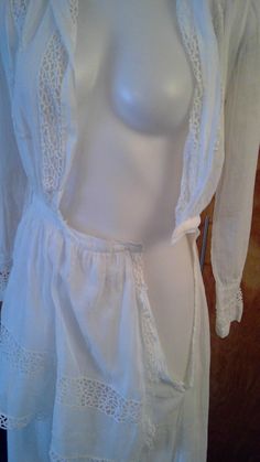 "Edwardian lingerie dress. Sheer white fabric with gorgeous lace inserts and trim. Wide sailor style collar . Bodice opens to a deep v. Front and back apron like panels. This is in such great condition for a dress that's 100 years old. No stains or holes. I made one repair to a break in the insert lace in one of the lower tiers of the skirt. All the hook and eye closures are missing so you will need to add them. Shown on my mannequin 34 1/2\" bust, 26\" waist. 36\" hips My measurement taken flat Long Lace Dress For Daywear, Feminine Fitted Victorian Daywear Dress, Fitted Feminine Victorian Dress For Daywear, Feminine Fitted Victorian Dress For Daywear, Open Front White Dress For Daywear, White Open Front Daywear Dress, White Open Front Dress For Daywear, Daywear Victorian Dress With Lace Patchwork, Vintage White Victorian Dress With Lace Trim For Daywear