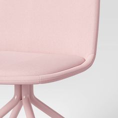 a pink chair sitting on top of a white floor