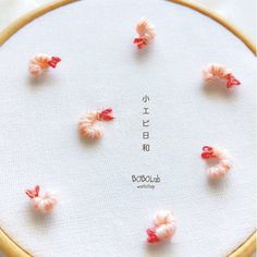 the embroidery is decorated with small pink flowers