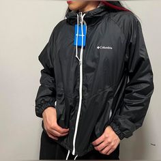 Bnwt Black Lightweight Columbia Windbreaker With Soft Lined Interior And Attached Hood Featuring Adjustable Drawstrings At The Hood And At The Bottom Of The Jacket Black Techwear Track Jacket With Moisture-wicking, Black Waterproof Track Jacket For Sports, Black Waterproof Athleisure Outerwear, Black Nylon Track Jacket, Functional Black Hooded Long Sleeve Jacket, Fall Black Moisture-wicking Track Jacket, Black Nylon Windproof Track Jacket, Black Sportswear Windbreaker For Outdoor Activities, Casual Black Hooded Jacket For Outdoor Activities