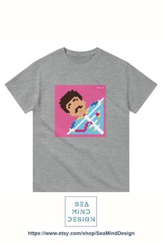 a t - shirt with an image of a man holding a surfboard on it