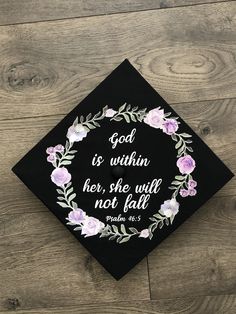 a graduation cap with the words god is within her, she will not fall