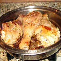 two pieces of chicken sitting in a metal bowl on the stove top, ready to be cooked