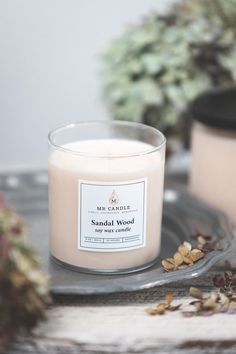 a candle sitting on top of a table next to potted plants and other items