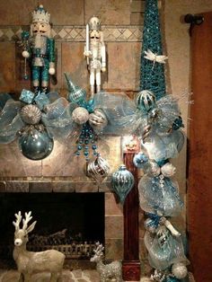 a fireplace decorated with blue and silver ornaments