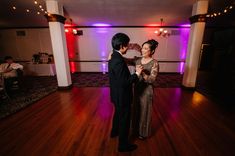 a man and woman dancing on a dance floor