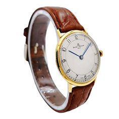 Men's Baume & Mercier 33mm Vintage 18K Yellow Gold Automatic Watch with Brown Leather Band and Egg-Shell Dial. Pre-Owned SN# 340**** Crystal: Plastic. Gender: Men's. Condition: Excellent. Dial Color: Egg-Shell. Movement: Automatic. Case Diameter: 33mm. Brand: Baume & Mercier. Case Material: 18K Yellow Gold. Bezel Material: 18K Yellow Gold. Bracelet Material: Aftermarket Brown Leather Strap. Warranty: Includes One (1) Year Limited Service Warranty. NOTE: The band / strap and buckle are not the or Classic Yellow Gold Watches With Polished Finish, Classic Yellow Gold Watches For Formal Occasions, Classic Yellow Gold Chronometer Watch, Classic Yellow Gold Watch With Chronometer, Timeless Yellow Gold Watch Accessories For Business, Vintage White Gold Business Watches, Classic Yellow Gold Watch Accessories For Business, Classic Yellow Gold Chronometer Watch Accessories, Classic Yellow Gold Formal Watch Accessories