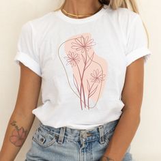 Boho Abstract Floral Shirt, Flowers Graphic Tee, Boho Tshirt, Botanical Shirt, Abstract Tee, Minimalist Tee, Cute Women's Tee, Gift for Her MADE IN THE U.S.A. PLEASE READ BEFORE PURCHASING Production: 1-4 business days Shipping: 2-5 business days (We have no control over delays related to the postal service) *PLEASE EXPECT DELAYS DURING THE HOLIDAYS* SIZING The Bella + Canvas 3001 tee is a unisex fit, meaning it's a bit more slim through the midsection than a traditional men's tee, but not quite as fitted as a women's tee. Women should size down for a more fitted look and size up for a looser fit. Please be sure to check the size chart photo. We recommend measuring one of your tees at home and comparing it with the size chart.  NO RETURNS, EXCHANGES, OR CANCELLATIONS Because our shirts are Minimalist Graphic Print Short Sleeve Tops, Minimalist Cotton Top With Graphic Print, Trendy Short Sleeve Shirt With Plant Print, White Casual T-shirt With Plant Print, Pink T-shirt With Plants Print In Relaxed Fit, Trendy Crew Neck Tops With Plants Print, Trendy Crew Neck Shirt With Plant Print, Casual White T-shirt With Plant Print, White Short Sleeve T-shirt With Plant Print