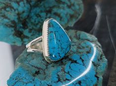 Handcrafted Ithica Peak Turquoise Ring - Vibrant Kingman Blue - Old Stock Gemstone. Eye popping Kingman blue turquoise ring in Sterling Silver. Old stock from turquoise mountain. Ithica Peak deep blue with black webbed matrix. Elegant gift for her. This is some of Sondra's favorite stock.  The Kingman Turquoise rough was purchased from the family of an old Southwest jeweler. Several pounds were purchased with the receipt of 1980s purchase from Larry Cooley as Kingman Sample lot. This is rare to find in the rough today. It is from our private collection. The stone was cut and set by Marvin Boone of Boone Silversmith. Kingman Turquoise is one of the longest running turquoise mines in the United States. It is the last large turquoise mine left in the US. This was mined in the late 70s to earl Luxury Silver Kingman Turquoise Ring, Southwestern Multi-stone Turquoise Ring, Sterling Silver Multi-stone Turquoise Ring, Jewelry Western, Blue Gemstone Ring, One-of-a-kind Silver Turquoise Ring In Sterling Silver, Blue Multi-stone Turquoise Ring In Sterling Silver, Unique Silver Rings, Accessories Blue