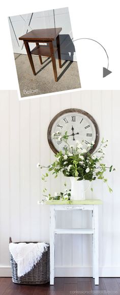 a white table with a clock on the wall and flowers in a vase next to it