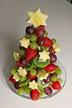 a christmas tree made out of fruit on a plate