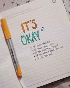 it's okay written on lined paper next to a pen