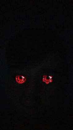 two red eyes are glowing in the dark