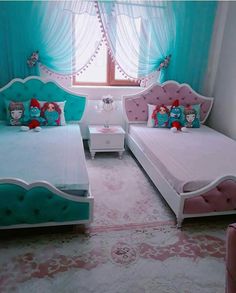 a bedroom with two twin beds and blue drapes on the windowsill, pink rugs in front of them