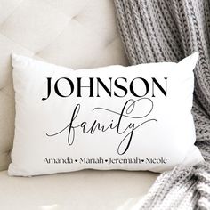 a personalized pillow sitting on top of a white couch next to a gray blanket