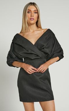 Show off a sexy sophistication in the Anastasija Dress! This stunning mini dress has a sculptural off-the-shoulder neckline, elbow-length puff sleeves and a fitted waist with darts at the skirt for a slim fit. It's highly chic and perfect to wear for special events or occasions. Pop it on for date night with layered necklaces, hoops and some sleek heels!Product DetailsInvisible zipper on the centre backOff-the-shoulder V-necklineElbow-length balloon sleeves with elasticated cuffsGathered bodice& Off Shoulder V Neck, Black Dress Outfit Party, Off Shoulder Mini Dress, Gathered Bodice, Black Dress Outfits, Pop It, Balloon Sleeves, Fancy Dresses, V Neck Dress