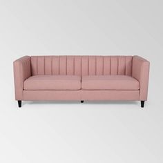 a pink couch sitting on top of a white floor