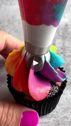 a cupcake that has been decorated with colorful icing