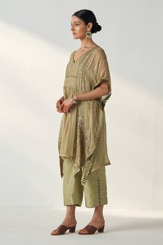 Green batwing sleeves kaftan with florence garden embroidery and shimmery stripes detailing. Paired with a contrast piping and polki button embellished pant and an inner. - Aza Fashions Bohemian Kaftan With Cape Sleeves For Festive Season, Festive Bohemian Kaftan With Cape Sleeves, Traditional Embellished Chanderi Kaftan, Festive Embellished Kaftan With Kimono Sleeves, Festive Tunic Kaftan For Transitional Season, Festive Kaftan With Zari Work And Cape Sleeves, Traditional Chikankari Embroidered Dupatta, Traditional Dupatta With Chikankari Embroidery And Cape Sleeves, Traditional Chikankari Embroidery Dupatta With Cape Sleeves