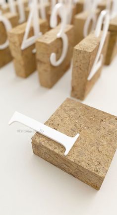 cork blocks with white numbers and a toothbrush on them sitting in front of each other