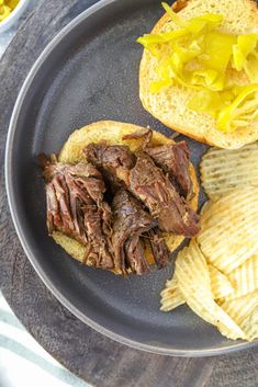 a steak sandwich and chips on a plate