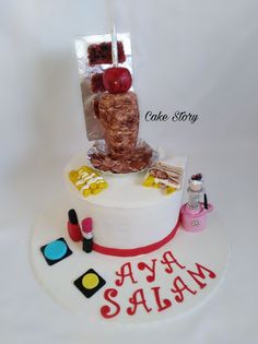 a white cake with an assortment of items on it and the words happy sale written in red