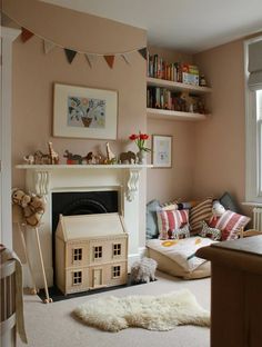 a living room filled with furniture and a fire place next to a book shelf full of books