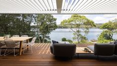 a living room with wooden flooring and furniture on top of a hard wood floor