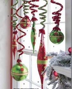 christmas decorations hanging from a window sill