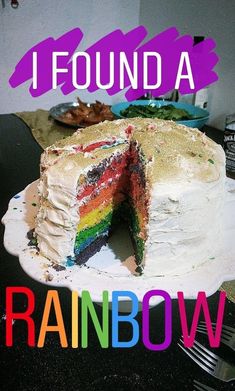 a rainbow cake with the words i found a rainbow on it and there is a slice missing