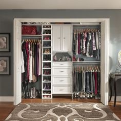 a walk in closet filled with lots of clothes and shoes on top of shelves next to a rug