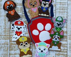 several patches with dogs on them sitting next to each other in front of a wooden background